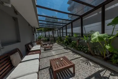 a balcony with benches and plants on a building at 7Palms in Rhodes Town