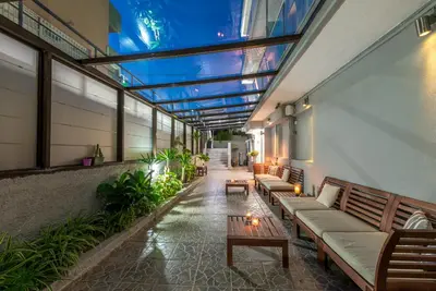 a building with benches and tables and a glass ceiling at 7Palms in Rhodes Town