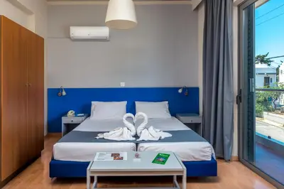 a hotel room with a bed with towels on it at 7Palms in Rhodes Town