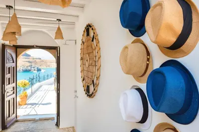 a hallway with hats hanging on the wall at Lindos Shore Summer House with Jacuzzi and sea view !!! in Líndos