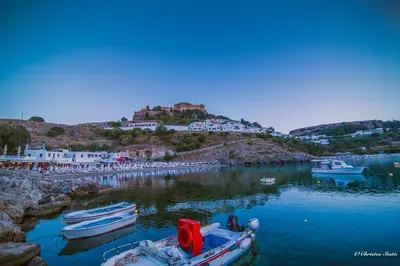 a group of boats docked in a body of water at Lindos Shore Summer House with Jacuzzi and sea view !!! in Líndos