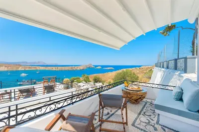 a balcony with a view of the water at Lindos Shore Superior Studio in Líndos