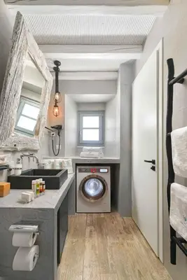 a bathroom with a washing machine and a sink at Lindos Shore Superior Studio in Líndos