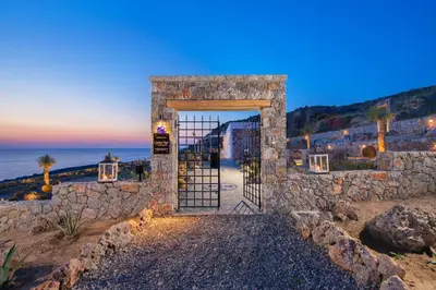 an entrance to a stone building with a gate at Lindos Vigli Private Villa in Líndos