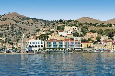 a town on the shore of a body of water at Nireus Hotel in Symi