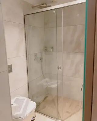 a shower stall in a bathroom with a toilet at Nireus Hotel in Symi