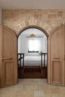 an archway leading into a bedroom with a bed at Villa Akti in Lachania