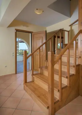 a wooden staircase in a home with aoyer with wooden stairs at Villa Lahania in Lachania