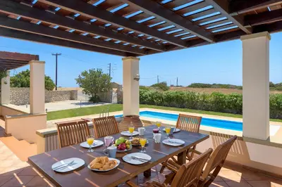a table with food on it on a patio at Villa Lahania in Lachania