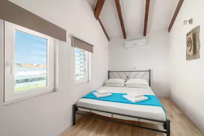 a small bedroom with a bed and a window at Kolymbia Villas by StayonRhodes in Kolimbia