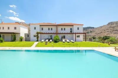 a large swimming pool in front of a house at Kolymbia Villas by StayonRhodes in Kolimbia