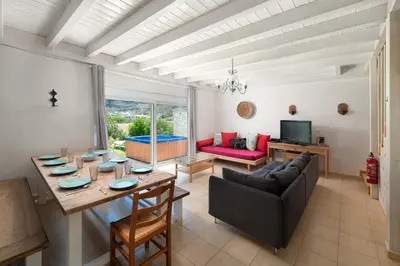 a living room with a table and a couch at Kolymbia Villas by StayonRhodes in Kolimbia