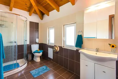 a bathroom with a toilet and a sink and a shower at Kolymbia Villas by StayonRhodes in Kolimbia