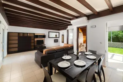 a living room with a table and a couch at Kolymbia Villas by StayonRhodes in Kolimbia