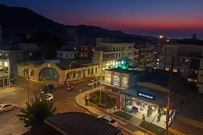 a view of a city at night at Apartment Dream Holidays - 500 meters to beach in Ialyssos