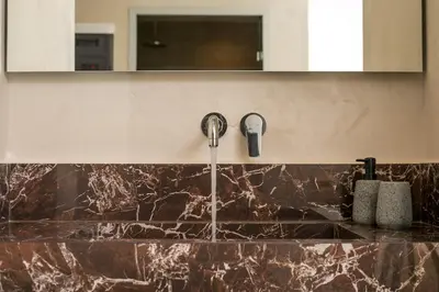 a kitchen with a sink with a faucet at Ano Kampos Hotel in Faliraki