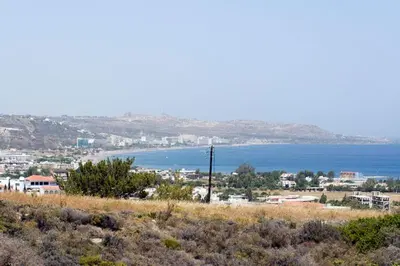 a view of a city and the ocean from a hill at Ano Kampos Hotel in Faliraki