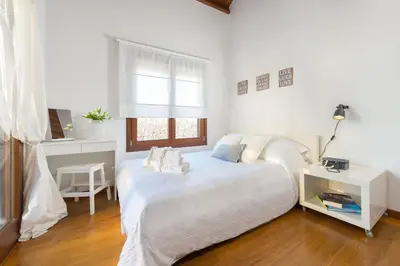 a white bedroom with a bed and a window at Katerina Boutique Villa in Rhodes Town
