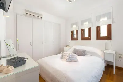 a white bedroom with a bed and a desk at Katerina Boutique Villa in Rhodes Town