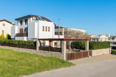 a house on a hill with a stone wall at Katerina Boutique Villa in Rhodes Town