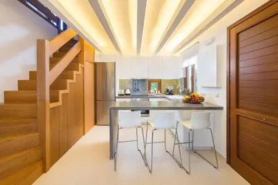 a kitchen with a dining table and stools at Katerina Boutique Villa in Rhodes Town