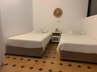 two beds sitting in a room with at Haraki Beach House in Haraki
