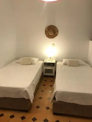 two beds sitting next to each other in a room at Haraki Beach House in Haraki