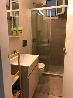 a bathroom with a toilet and a glass shower at Haraki Beach House in Haraki