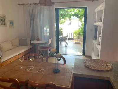 a living room with a table with wine glasses on it at Haraki Beach House in Haraki