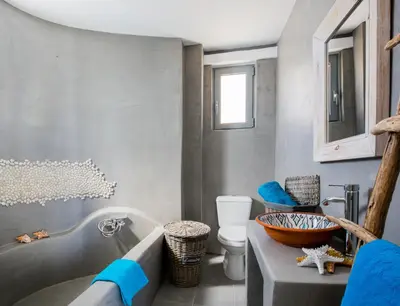 a bathroom with a tub and a toilet and a sink at Axiotheaton Villas in Pefki Rhodes