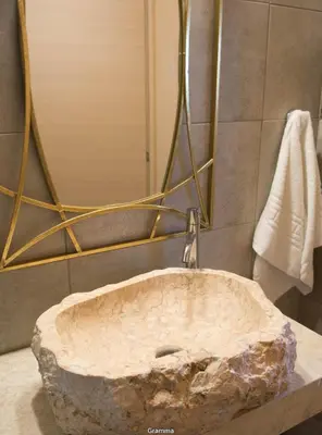 a bathroom with a stone sink with a faucet at Villa Sealine in Pefki Rhodes