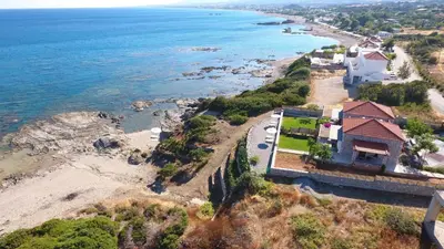 an aerial view of a house on the shore of a beach at Alisahni Beachfront Villas in Kiotari