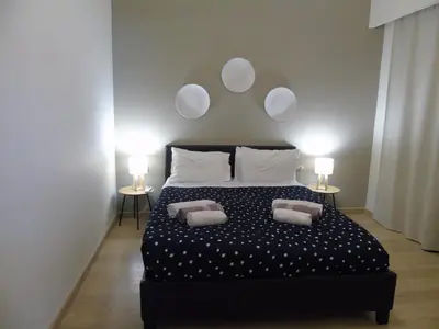 a bedroom with a bed with two pillows on it at Vasiliki Villa in Ialyssos