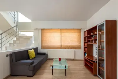 a living room with a couch and a table at Vasiliki Villa in Ialyssos