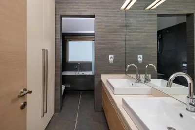 a bathroom with two sinks and a window at Vasiliki Villa in Ialyssos