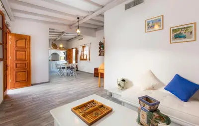 a living room with a white couch and a table at Lindos Seaside Villa in Líndos