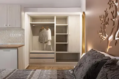 a bedroom with a closet with a dresser at Chrysanthi Studios in Líndos