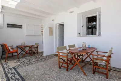 a dining room with wooden tables and chairs at Chrysanthi Studios in Líndos