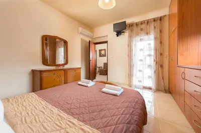 a bedroom with a bed with two towels on it at Natura House in Ialyssos