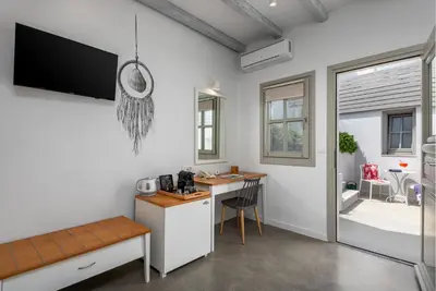 a room with a desk and a computer in it at Lindos Comfy Suites in Líndos