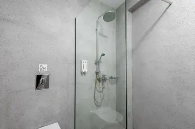 a shower in a bathroom with a glass door at Lindos Comfy Suites in Líndos