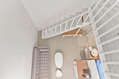 a bathroom with white shelves and a white staircase at Lindos Comfy Suites in Líndos