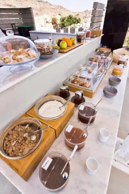 a buffet line with many different types of food at Lindos Comfy Suites in Líndos