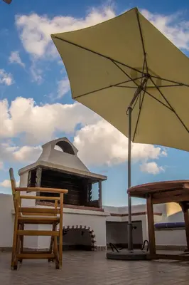 a yellow umbrella sitting next to a table and chairs at Villa Dome in Gennadi