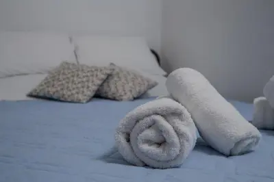 a bedroom with a bed with towels on it at Villa Dome in Gennadi