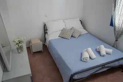 a bedroom with a bed with towels on it at Villa Dome in Gennadi