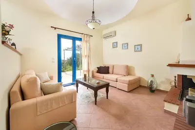 a living room with a couch and a table at Villa Dome in Gennadi