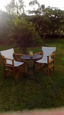 two chairs and a table with a drink on it at Villa Dome in Gennadi