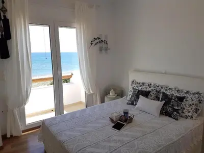 a bedroom with a bed with a view of the ocean at Villa Sevil in Lachania