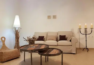 a living room with a couch and a table and candles at Villa Sevil in Lachania